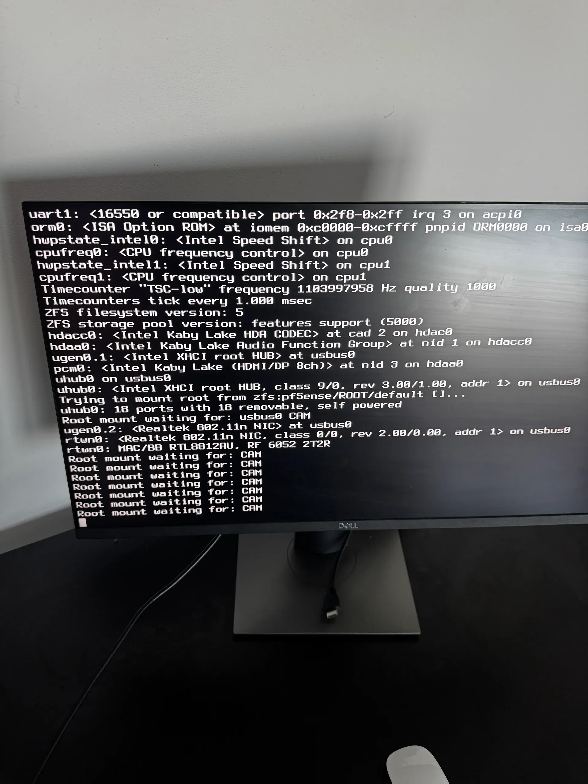 Kernel boot log — ZFS init, USB device enumeration, and CAM polling starting