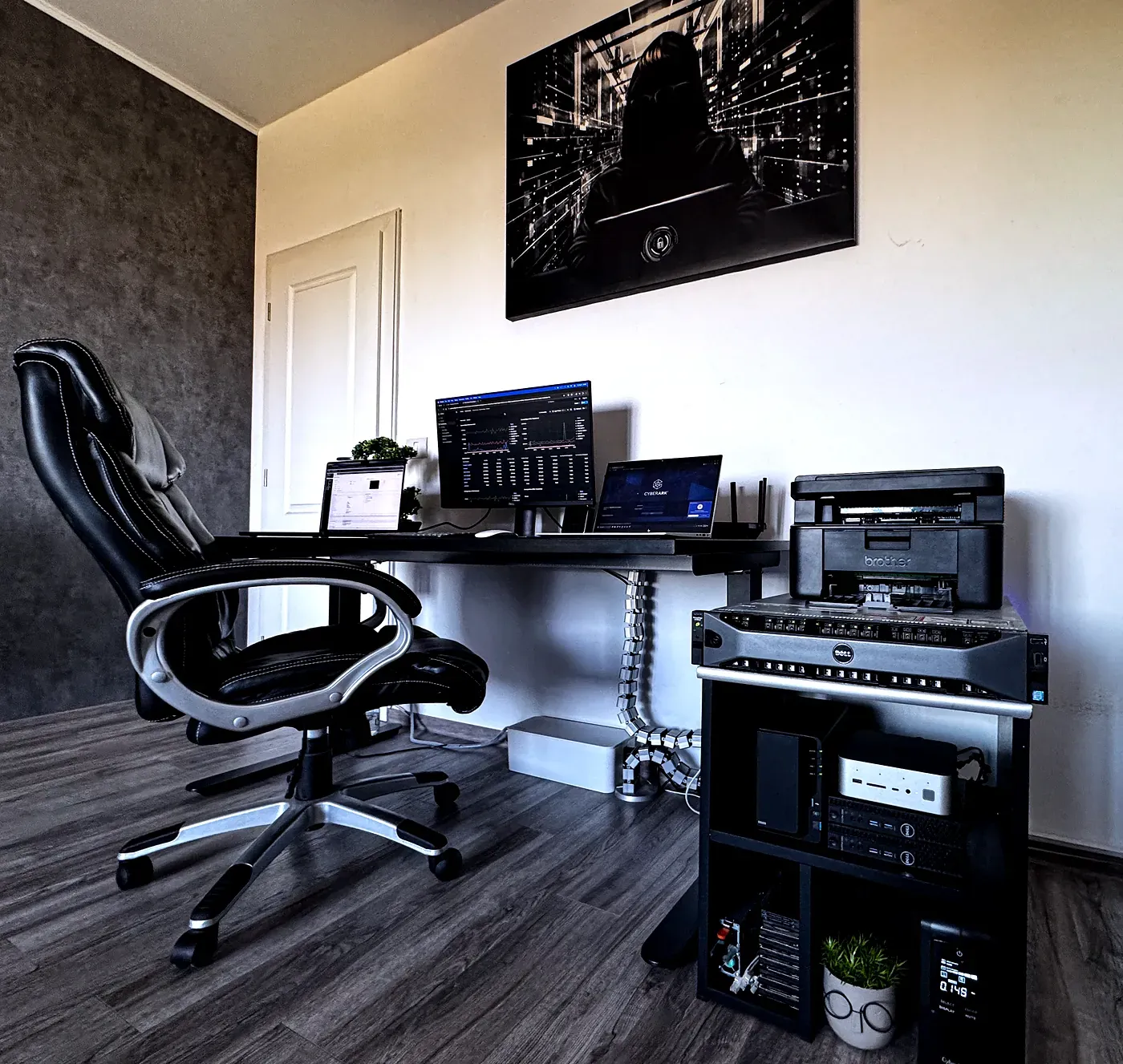 The office corner: a standing desk running monitoring dashboards, and the open rack beside it — R730xd, mini PCs, NAS and UPS