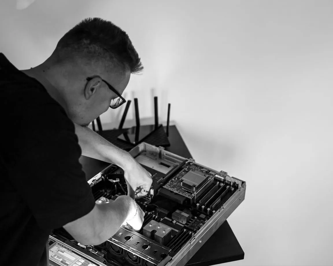 Me leaning over an opened rack server with the lid off, seating a component on the board