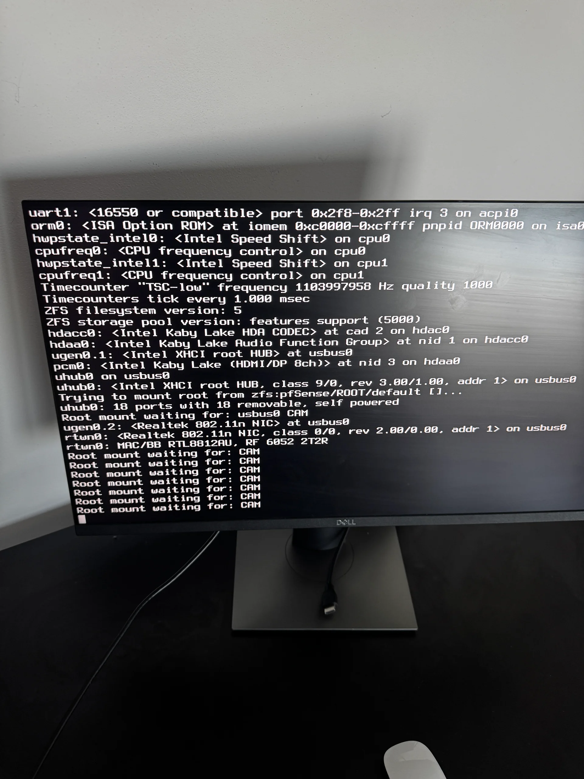 Kernel boot log — ZFS init, USB device enumeration, and CAM polling starting